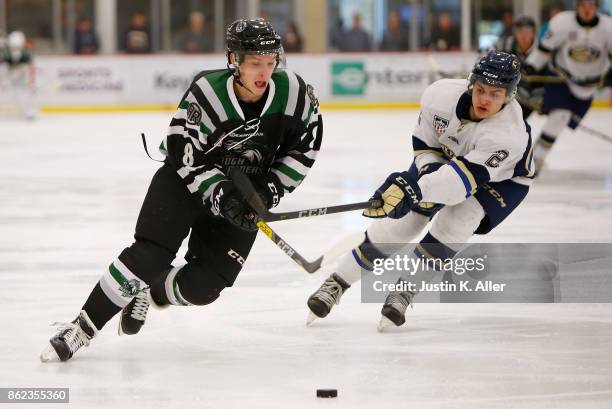 Harrison Roy of the Cedar Rapids RoughRiders skates with the puck against AJ Villella of the Sioux Falls Stampede during the game on Day 2 of the...