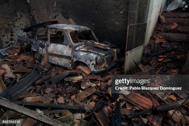 Car and a house are burnt near Penacova on October 17, 2017 in Coimbra region, Portugal. At least 37 people have died in fires in Portugal and 4...