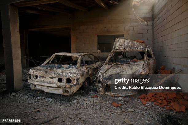 Cars and a house are burnt in the village of Travanca do Mondego on October 17, 2017 in Coimbra region, Portugal. At least 37 people have died in...