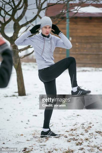 young sportsman exercising outdoors - the twist stock pictures, royalty-free photos & images