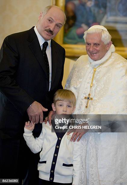 Pope Benedict XVI poses with Belarussian President Alexander Lukashenko and his son Nikolai during their meeting in the Vatican on April 27, 2009....