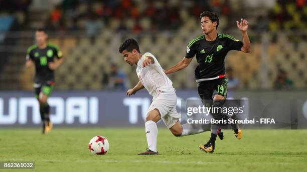 Mohammad Ghaderi of Iran is challenged by Diego Lainez of Mexico during the FIFA U-17 World Cup India 2017 Round of 16 match between Iran and Mexico...