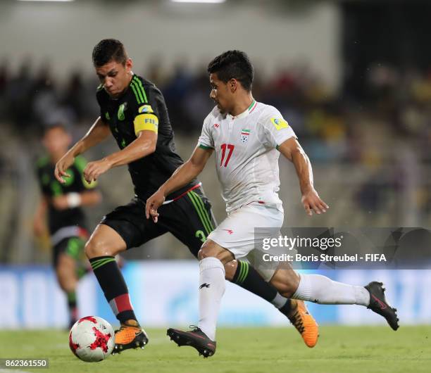 Mohammad Ghaderi of Iran is challenged by Carlos Robles of Mexico during the FIFA U-17 World Cup India 2017 Round of 16 match between Iran and Mexico...