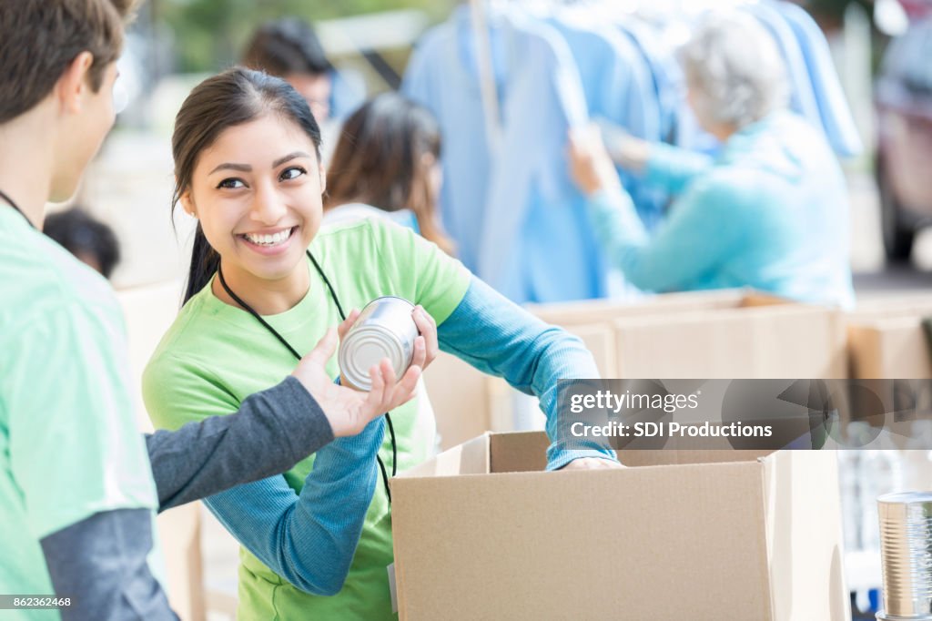 Male and female volunteers sort donations during food drive