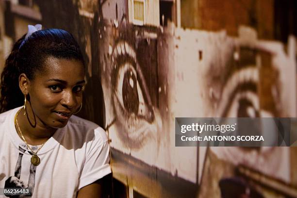 Roberta Gomes, a resident of the Providencia shantytown and with a participation in French photographer JR's work "Women", poses in front a picture...