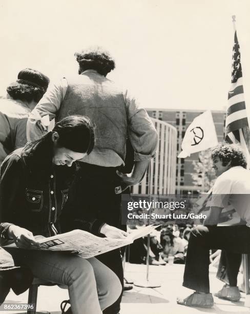 Students sit on stage and read a newspaper during an anti Vietnam War student sit-in protest at North Carolina State University, Raleigh, North...