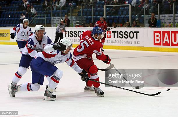 Jan Marek of Czech Republic fights for the puck with Tommy Jakobsen and Jonas Holos of Norway during the IIHF World Ice Hockey Championship...