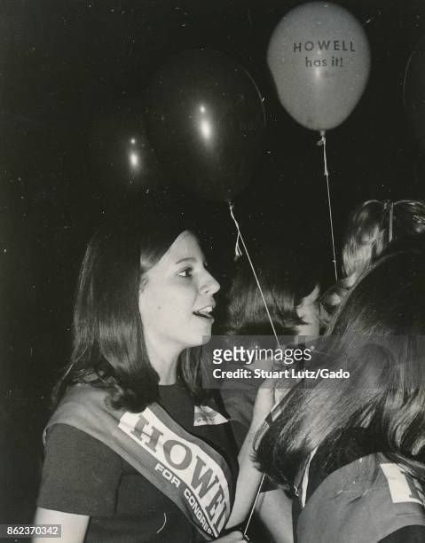 Young female coed college students march wearing sashes and holding balloons reading "Howell" at North Carolina State University, Raleigh, North...