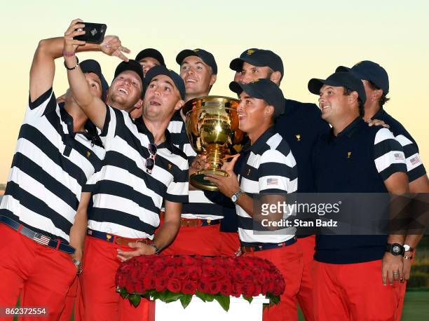 The U.S. Team takes a selfie with the Presidents Cup trophy after clinching the win during the Sunday singles matches at the Presidents Cup at...