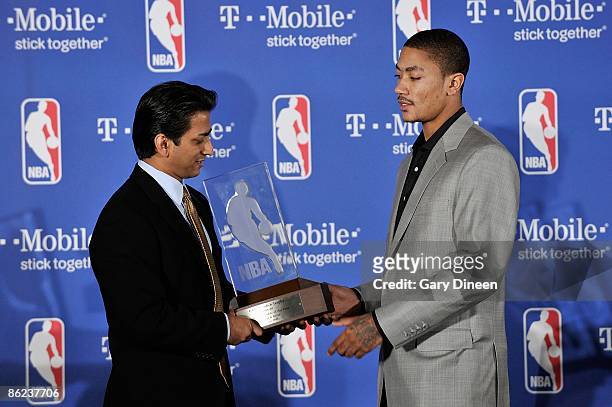 Raj Tank T-Mobile USA Vice President presents Derrick Rose of the Chicago Bulls with the Eddie Gottlieb trophy presented to the T-Mobile NBA Rookie...
