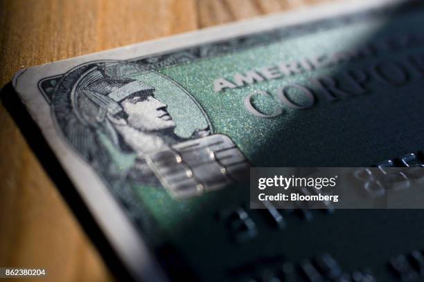 An American Express Co. Chip credit card is arranged for a photograph in Washington, D.C., U.S., on Sunday, Oct. 15, 2017. American Express is...