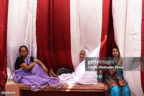 Widows watch the re-marriage ceremony of Vinita Devi, a widow, got remarried with Rakesh Kumar at Gopinath Temple, on October 16, 2017 in Vrindavan,...