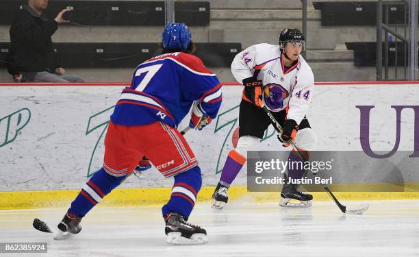 Gianfranco Cassaro of the Youngstown Phantoms handles the puck while being defended by Mike Hardman of the Des Moines Buccaneers during the game on...