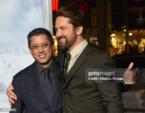 Director Dean Devlin and actor Gerard Butler arrive for the Premiere Of Warner Bros. Pictures' "Geostorm" held at TCL Chinese Theatre on October 16,...