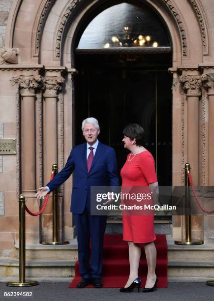 Former US President Bill Clinton gestures as he stands with DUP leader Arlene Foster at the Culloden Hotel following a private meeting on October 17,...