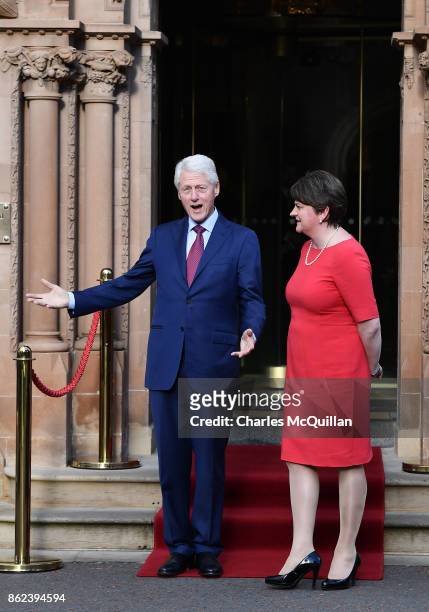 Former US President Bill Clinton gestures as he stands with DUP leader Arlene Foster at the Culloden Hotel following a private meeting on October 17,...