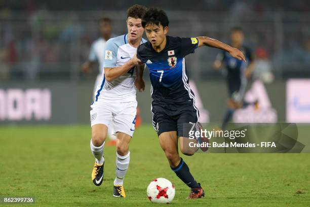George McEachran of England battles for the ball with Takefusa Kubo of Japan during the FIFA U-17 World Cup India 2017 Round of 16 match between...