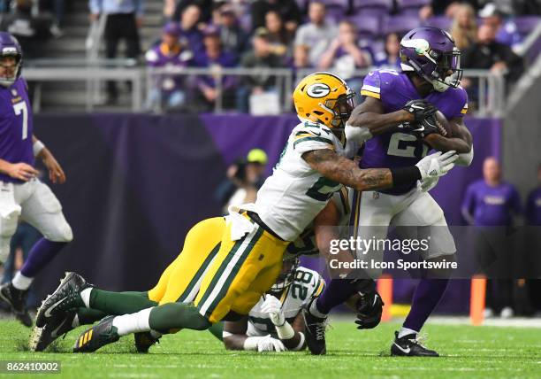 Green Bay Packers safety Josh Jones wraps up Minnesota Vikings running back Jerick McKinnon during a NFL game between the Minnesota Vikings and Green...