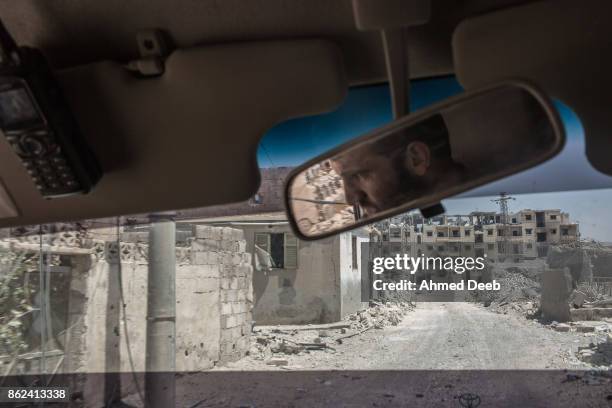 Member of the US-backed Syrian Democratic Forces drives an armored vehicle on the frontlines with Islamic State in the Edikhar housing near the Nahda...