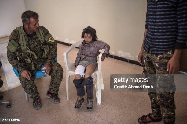 Syrian child sits in a military field hospital after he was injured by a mine which exploded when a group of civilians were escaping the Islamic...