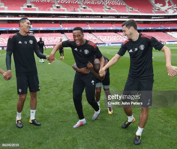 Chris Smalling, Anthony Martial and Matteo Darmian of Manchester United in action during a training session ahead of their UEFA Champions League...