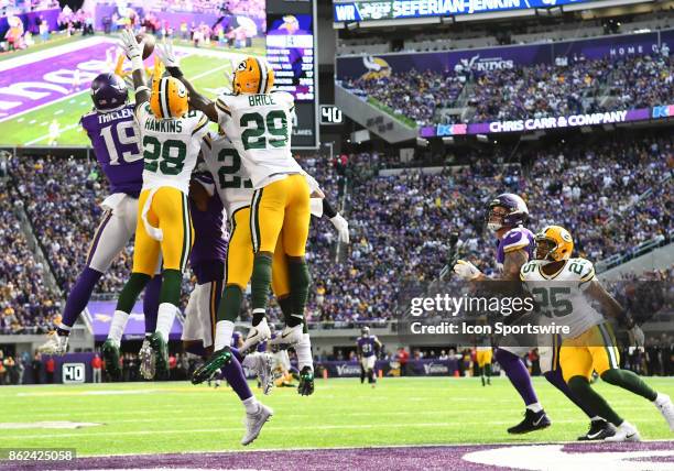 Minnesota Vikings wide receiver Adam Thielen goes up for a Hail Mary at the end of a half as Green Bay Packers cornerback Josh Hawkins , Green Bay...