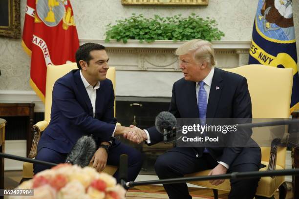 President Donald Trump welcomes Greek Prime Minister Alexis Tsipras in the Oval Office on October 17, 2017 at the White House in Washington, DC. A...