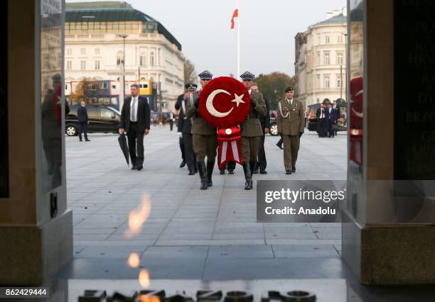 Soldiers carry the Turkish flag wreath of President of Turkey, Recep Tayyip Erdogan during his visit to the Tomb of the Unknown Soldier in Warsaw,...