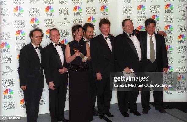 The production team for Shakespeare in Love pose backstage after receiving the award for Best Film - Musical or Comedy on January 24, 1999 at the...