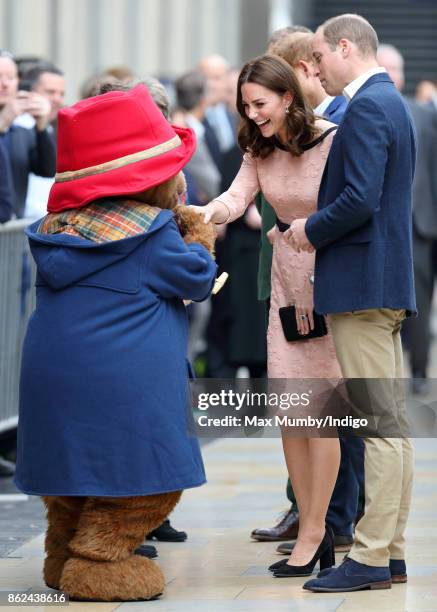 Prince William, Duke of Cambridge looks on as Paddington Bear greets Catherine, Duchess of Cambridge whilst they attend the Charities Forum Event at...