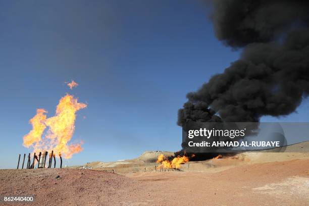 Picture taken on October 17, 2017 shows excess flammable gasses burning from gas flares at the Havana oil field, west of the multi-ethnic northern...