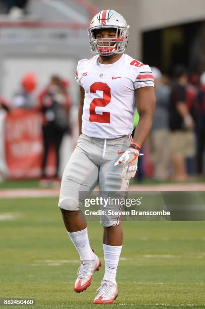 Running back J.K. Dobbins of the Ohio State Buckeyes warms up before the game against the Nebraska Cornhuskers at Memorial Stadium on October 14,...