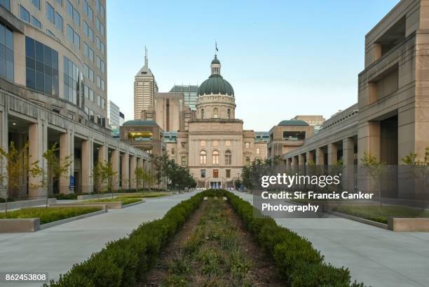 majestic indiana state capitol facade at dusk with skyscrapers on background in indianapolis, indiana, usa - indiana state capitol building stock pictures, royalty-free photos & images