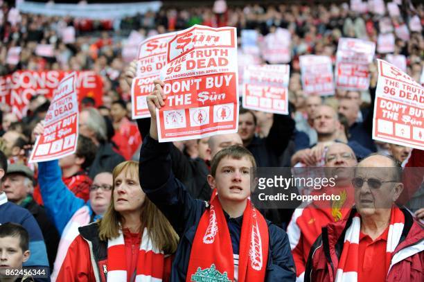 Liverpool fans hold up anti-Sun newspaper sheets before the FA Cup Semi Final match between Liverpool and Everton at Wembley Stadium on April 14,...