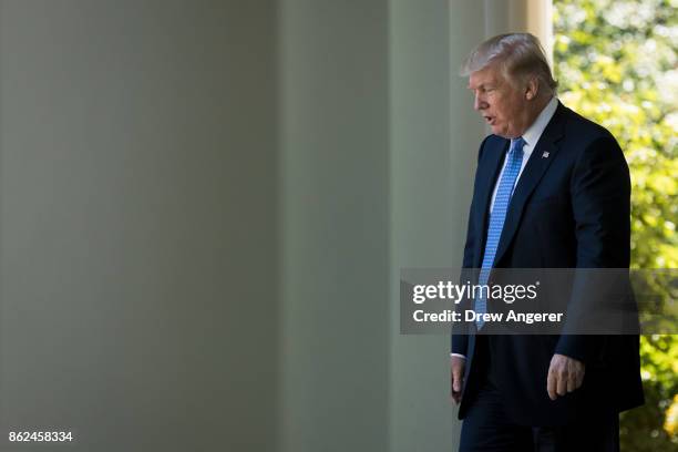 President Donald Trump arrives for a joint press conference with Greek Prime Minister Alexis Tsipras in the Rose Garden at the White House October...