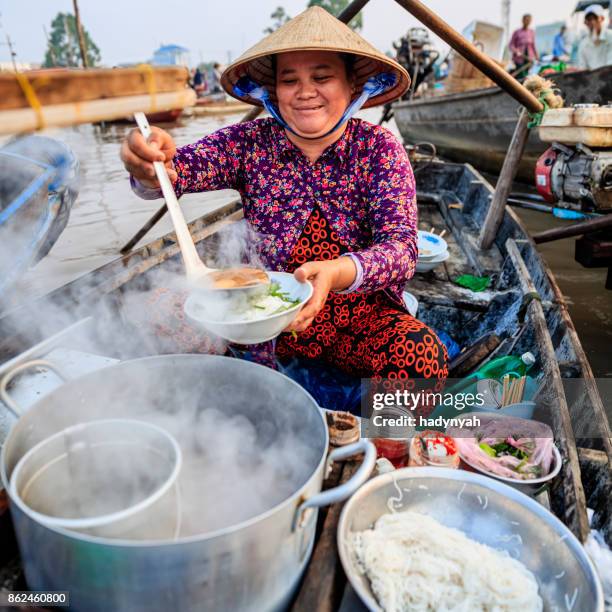 vietnamese woman selling famous noodle soup, floating market, mekong river delta, vietnam - vietnam fish stock pictures, royalty-free photos & images