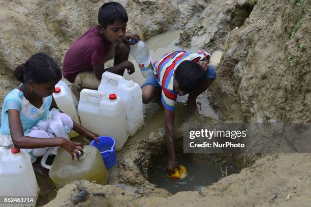 Rohingya children are collects drinking water from the Mud hole at the Unchiprnag Makeshift Camp in Cox's Bazar, Bangladesh, on September 07, 2017....