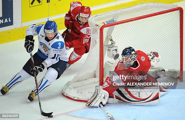 Finnish Petteri Nummelin tries to get around Danish goalie Sebastian Dahm, as Danish Mikkel Bodker of Phoenix Coyotes blocks him during their...