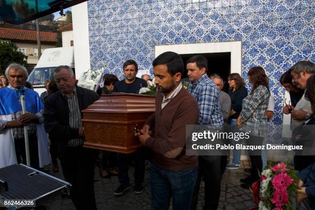 People carry a coffin during the funeral of a victim of a wildfire in the village of Vila Nova, near Vouzela on October 17, 2017 in Viseu region,...