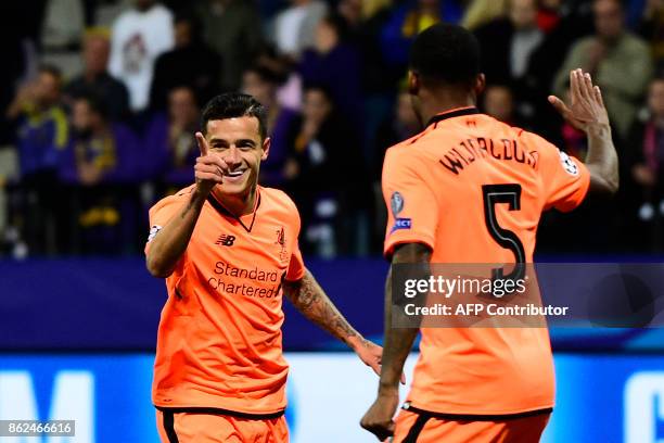 Liverpool's Brazilian midfielder Philippe Coutinho celebrates with teammates after scoring a goal during the UEFA Champions League group E football...