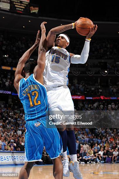 Carmelo Anthony of the Denver Nuggets goes up for a shot against Hilton Armstrong of the New Orleans Hornets in Game One of the Western Conference...