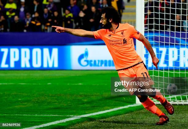 Liverpool's Egyptian forward Mohamed Salah celebrates after scoring a goal during the UEFA Champions League group E football match between NK Maribor...