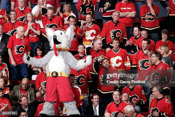 Calgary Flames mascot Harvey the Hound cheers with Calgary fans in the C of Red against the Chicago Blackhawks during Game Three of the Western...
