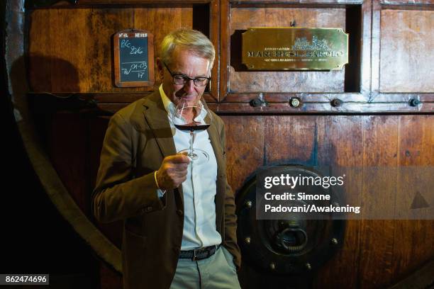 Ernesto Abbona the owner of Marchesi di Barolo winery, taste a glass of Barolo on October 17, 2017 in the Barolo region , Italy. Because of the high...