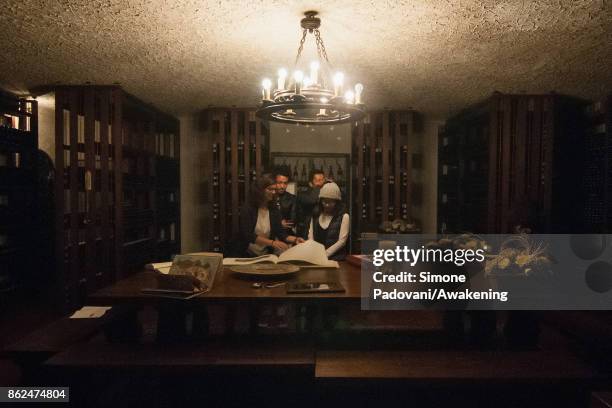 Tourists visit a winery of Barolo on October 17, 2017 in the Barolo region , Italy. Because of the high summer temperatures, Barolo's harvest has...