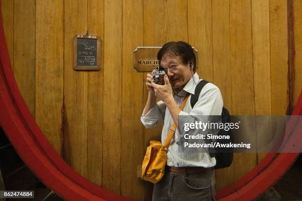 Tourist visits a winery of Barolo on October 17, 2017 in the Barolo region , Italy. Because of the high summer temperatures, Barolo's harvest has...