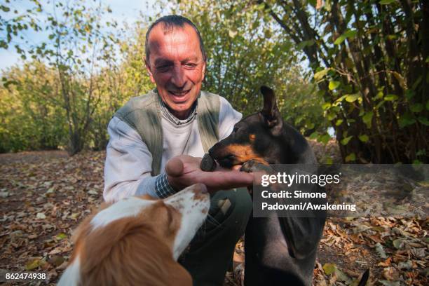 Gianni Monchiero, president of the University of truffle dogs in Roddi, let his dog smell a truffle to train them on October 17, 2017 in the Barolo...