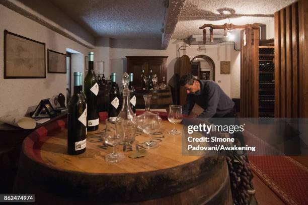 Worker prepare the tasting of Barolo for some visitors on October 17, 2017 in the Barolo region , Italy. Because of the high summer temperatures,...