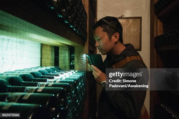 Tourist visits a winery of Barolo on October 17, 2017 in the Barolo region , Italy. Because of the high summer temperatures, Barolo's harvest has...