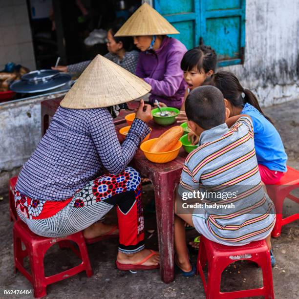 vietnamese children eating a pho bo, south vietnam - vietnam and street food stock pictures, royalty-free photos & images